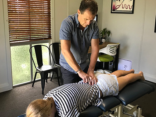 Chiropractor adjusting a patient's back