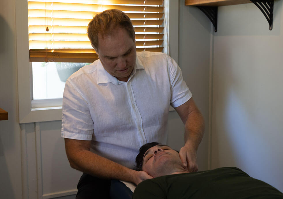 doctor adjusting patient