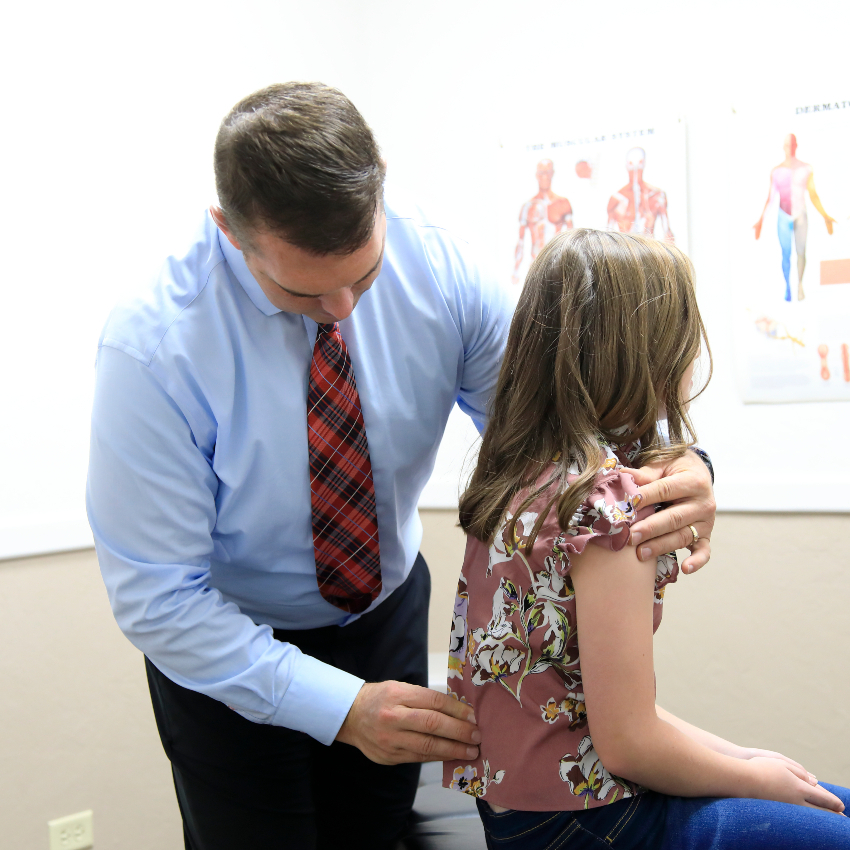 Pocatello chiropractor Dr Gary adjusting kids back