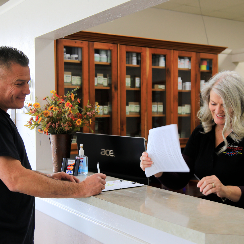 smiling patient at our front desk