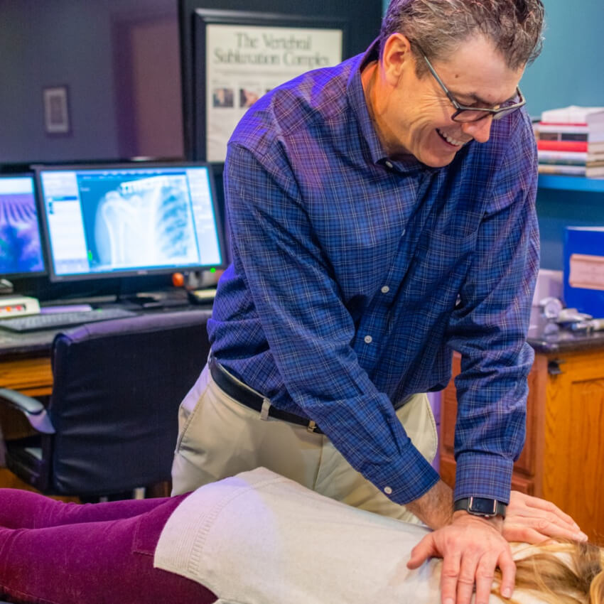 Glasgow chiropractor adjusting a female patient's back