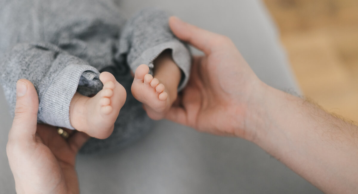 Chiropractor holding baby's feet