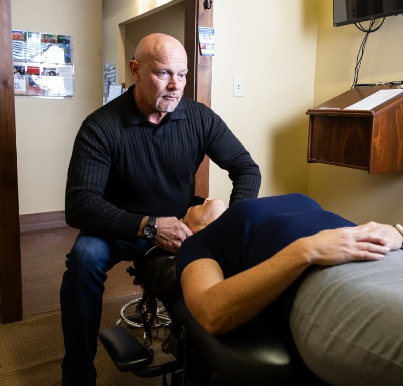 Pflugerville chiropractor adjusting patient's neck