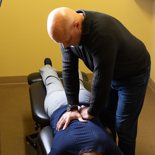 Pflugerville chiropractor adjusting patients back