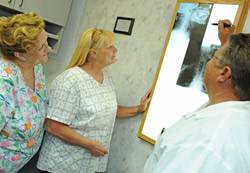 Dr. Jones, Cindy, and Alberta are discussing some x-ray results. Dr. Jones, Cindy, and Alberta are discussing some x-ray results.