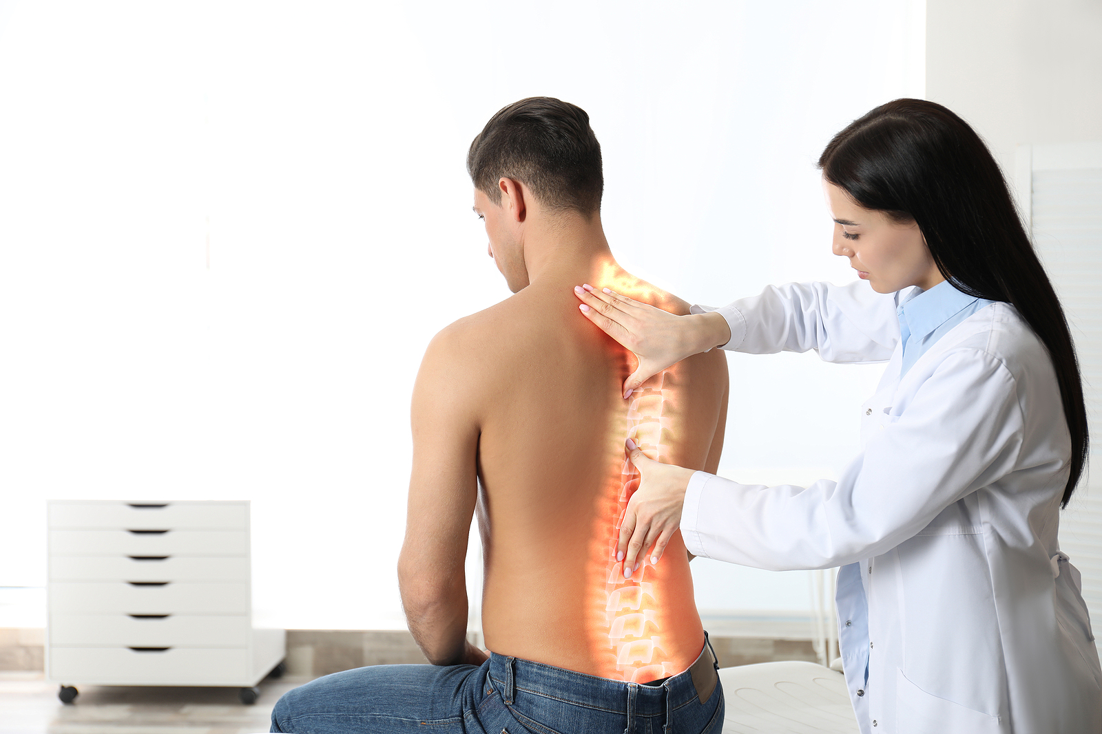 Professional Orthopedist Examining Man In Medical Office. Spinal