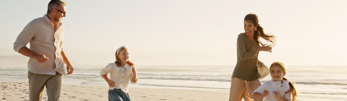 happy family running on a beach