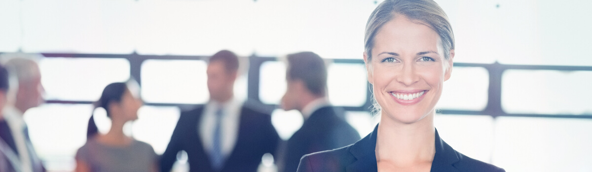 smiling business woman with people in the background