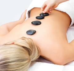 women receiving hot stone massage