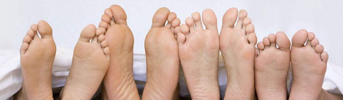 4 people's feet lined up in a row