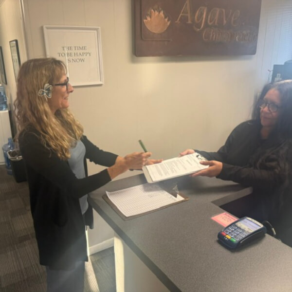 Receptionist in discussion with patient