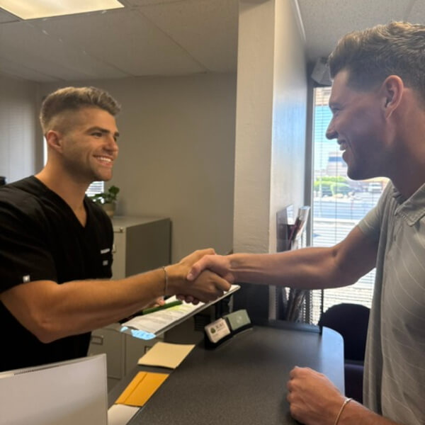 Chiropractor shaking hands with patient