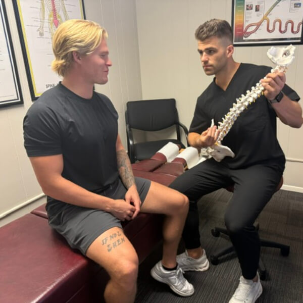 Chiropractor holding spine model