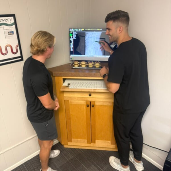 Chiropractor pointing at x-ray