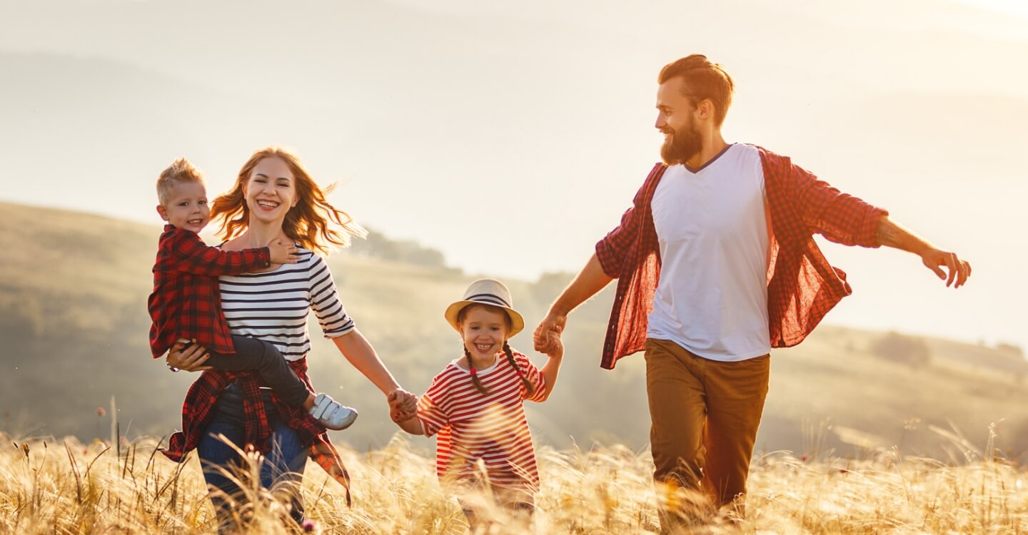 Happy young family holding hands