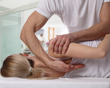 Female patient receiving upper-back-adjustment