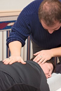 Chiropractor King of Prussia examines chiropractic patient. 