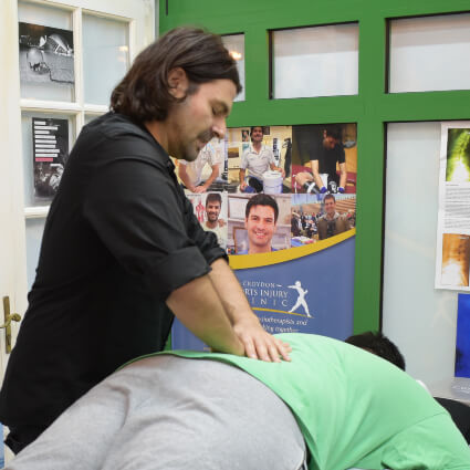 Dr Roddy adjusting patients upper back