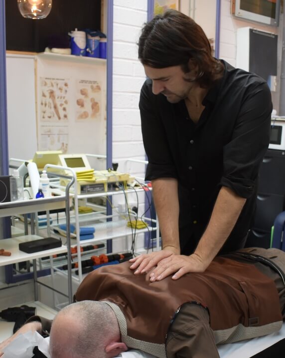 Dr. Roddy adjusting patients back