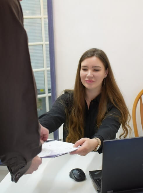our front desk staff giving patient a form
