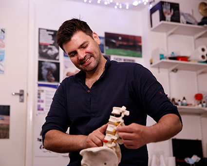 Dr. Roddy holding spine model