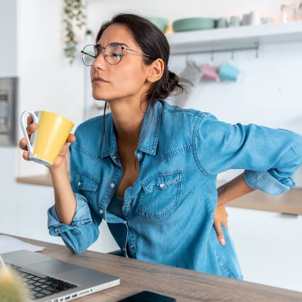 woman at desk with back pain