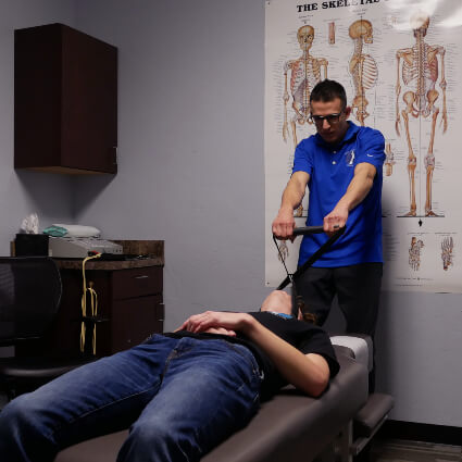 Chiropractor using y-strap