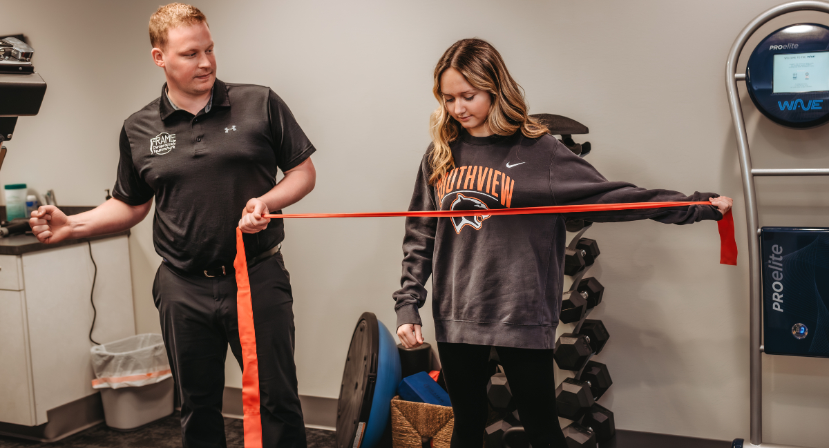 Physical therapist assisting patient with rehab exercises