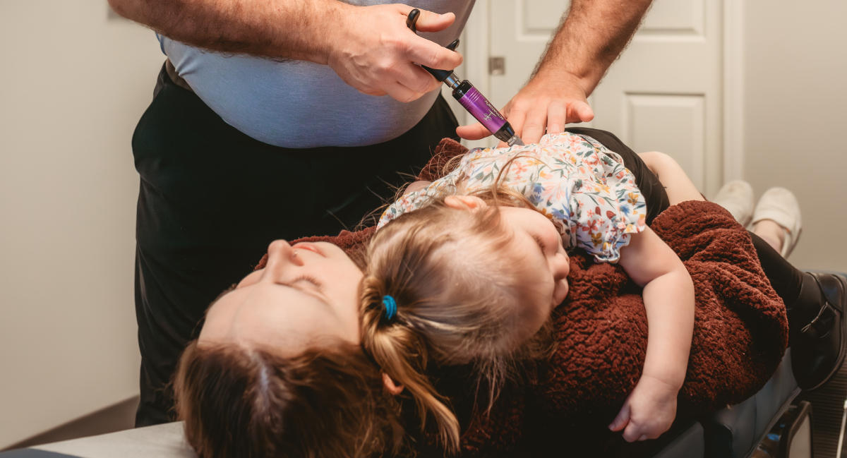 Toledo chiropractor adjusting pediatric patient