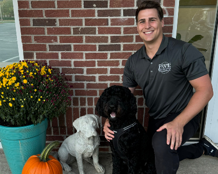 Dr. Zac Frame and black dog