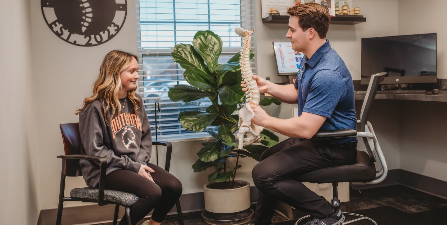 Toledo patient in a chiropractic consultation at Frame Chiropractic and Acupuncture