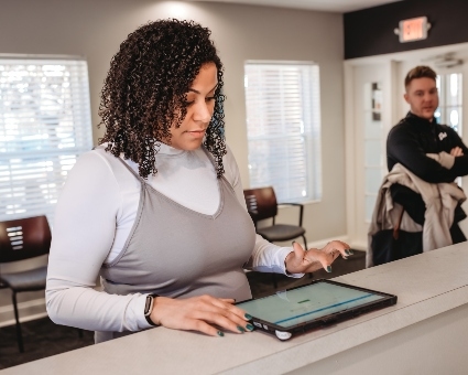 Patient completing paperwork on tablet