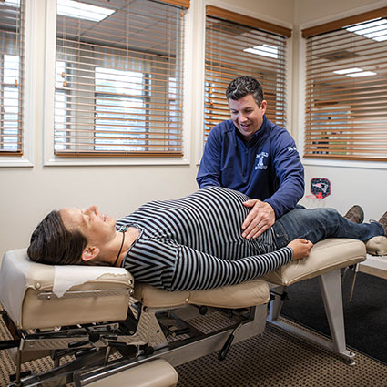 Dr. adjusting pregnant woman