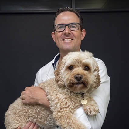 Dr. Paul holding pup