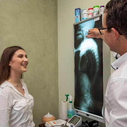 chiropractor showing patient xray