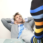 man with feet on desk