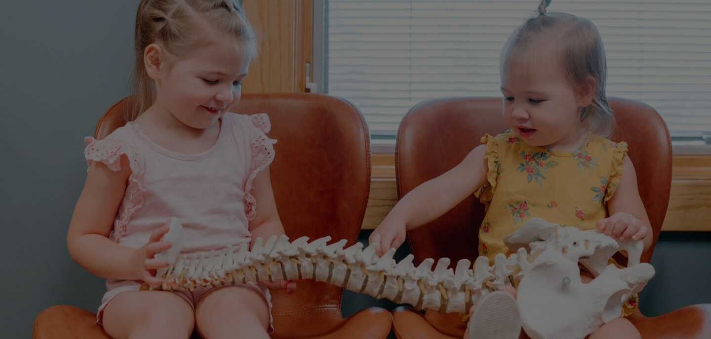 toddlers holding spine model