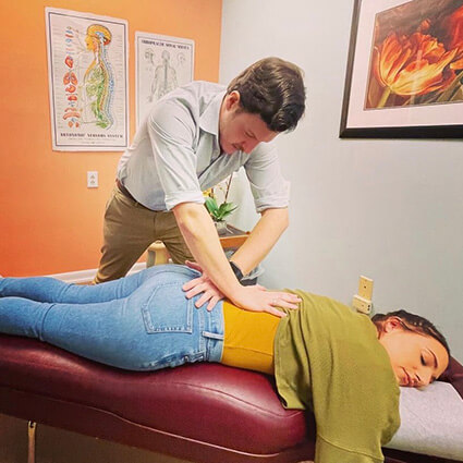 Hamilton Holistic Wellness Center doctor adjusting patients back