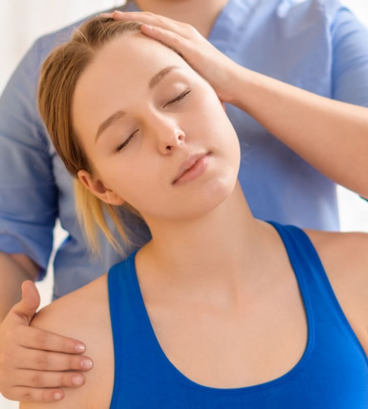 Female patient receiving a chiropractic neck adjustment