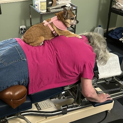 patient laying on adjusting table with grace on their back
