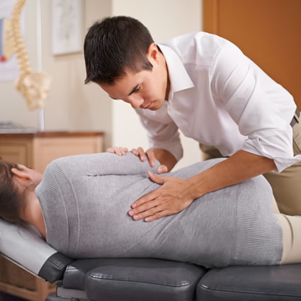 Woman getting manual chiropractic adjustment