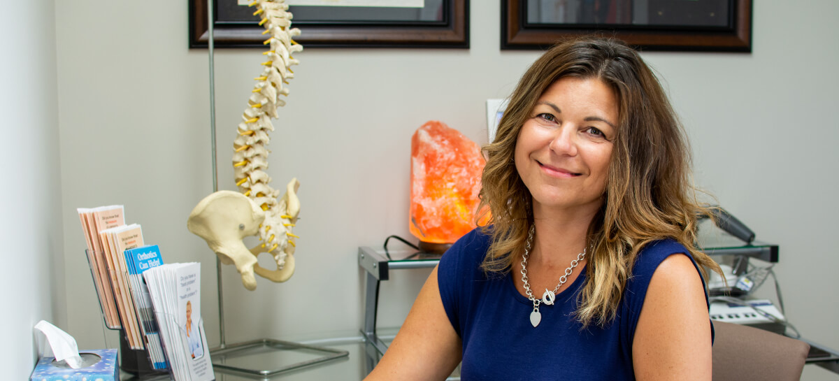 Dr. Nancy sitting at her desk