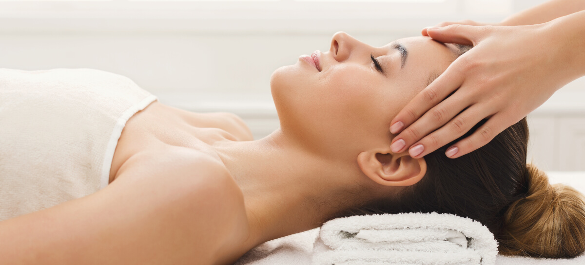 Female patient receiving a relaxed head massage