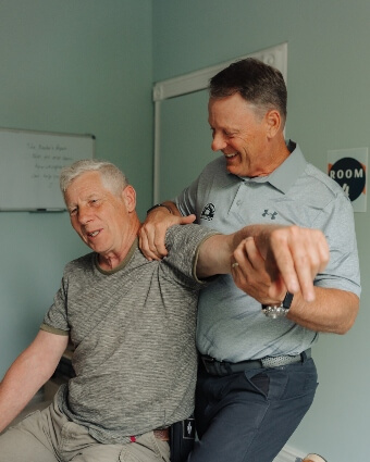 Dr. Stephen stretching male patient's arm