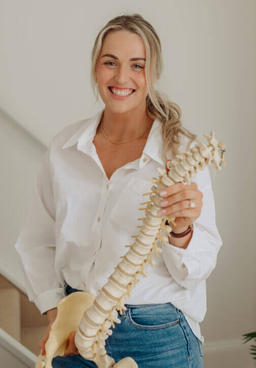 Dr. Cassie LaFay holding spine model