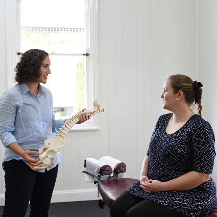 chiropractor consulting with a pregnant patient