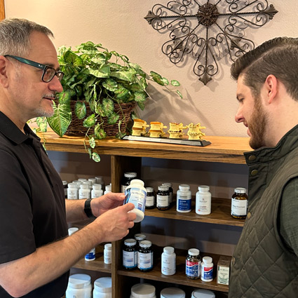 Dr. Samuel explaining supplements to a patient