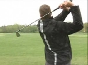 man swinging golf club