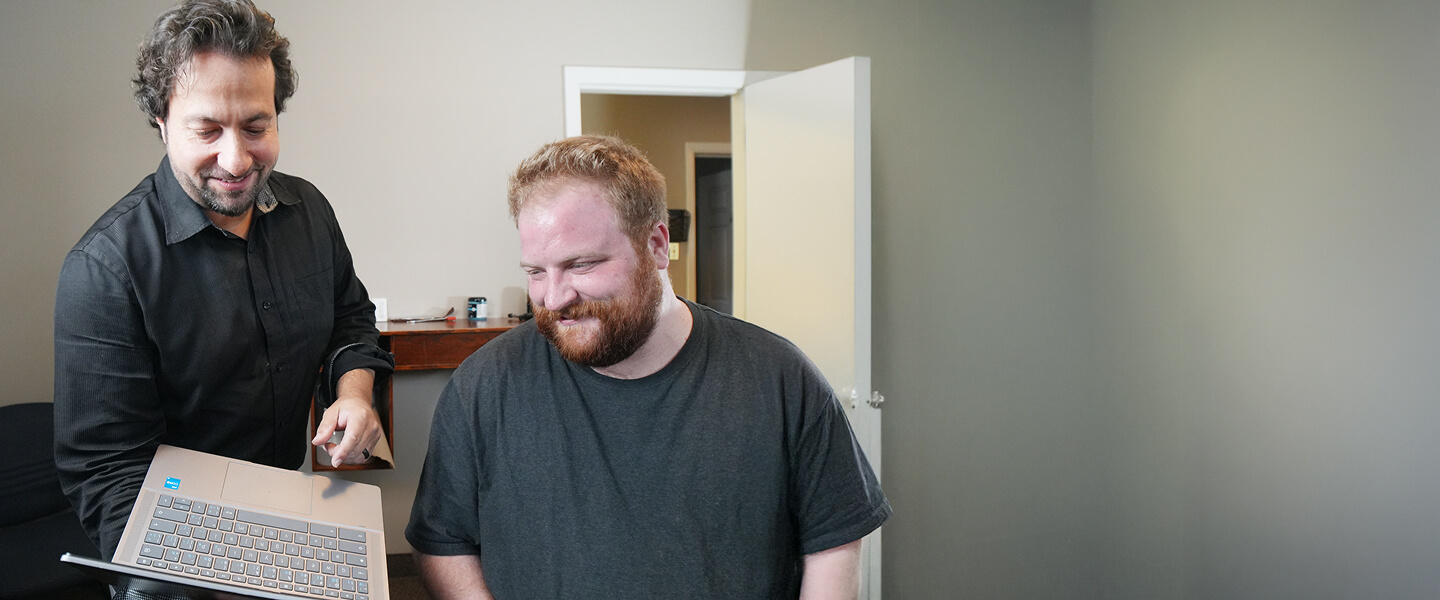 London chiropractor Dr Peter showing patient a computer