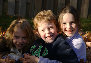 kids playing in the leaves